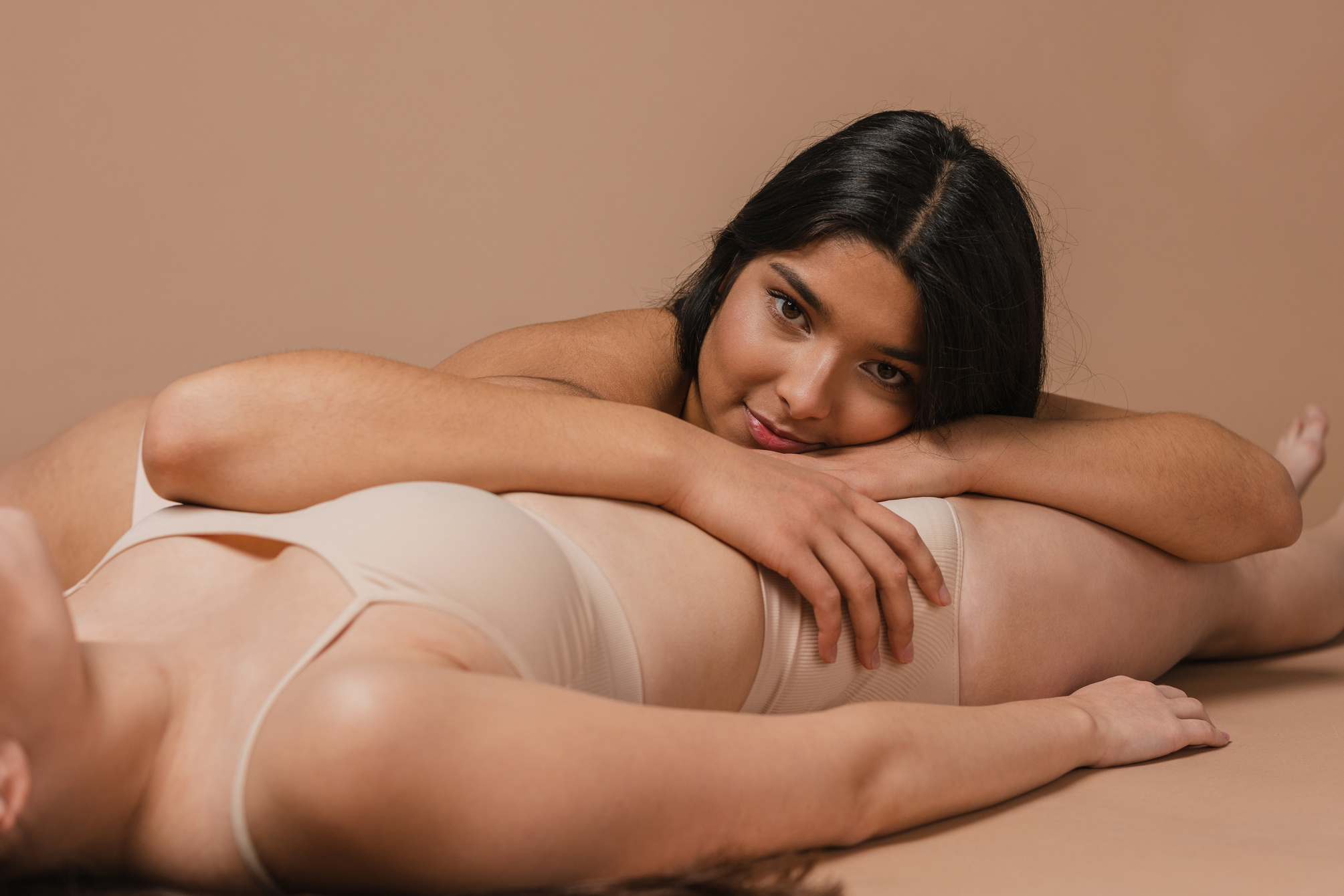 Women in Nude Underwear Lying on the Floor